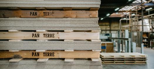 Panneaux d'isolation acoustique sur des palettes en bois dans un atelier